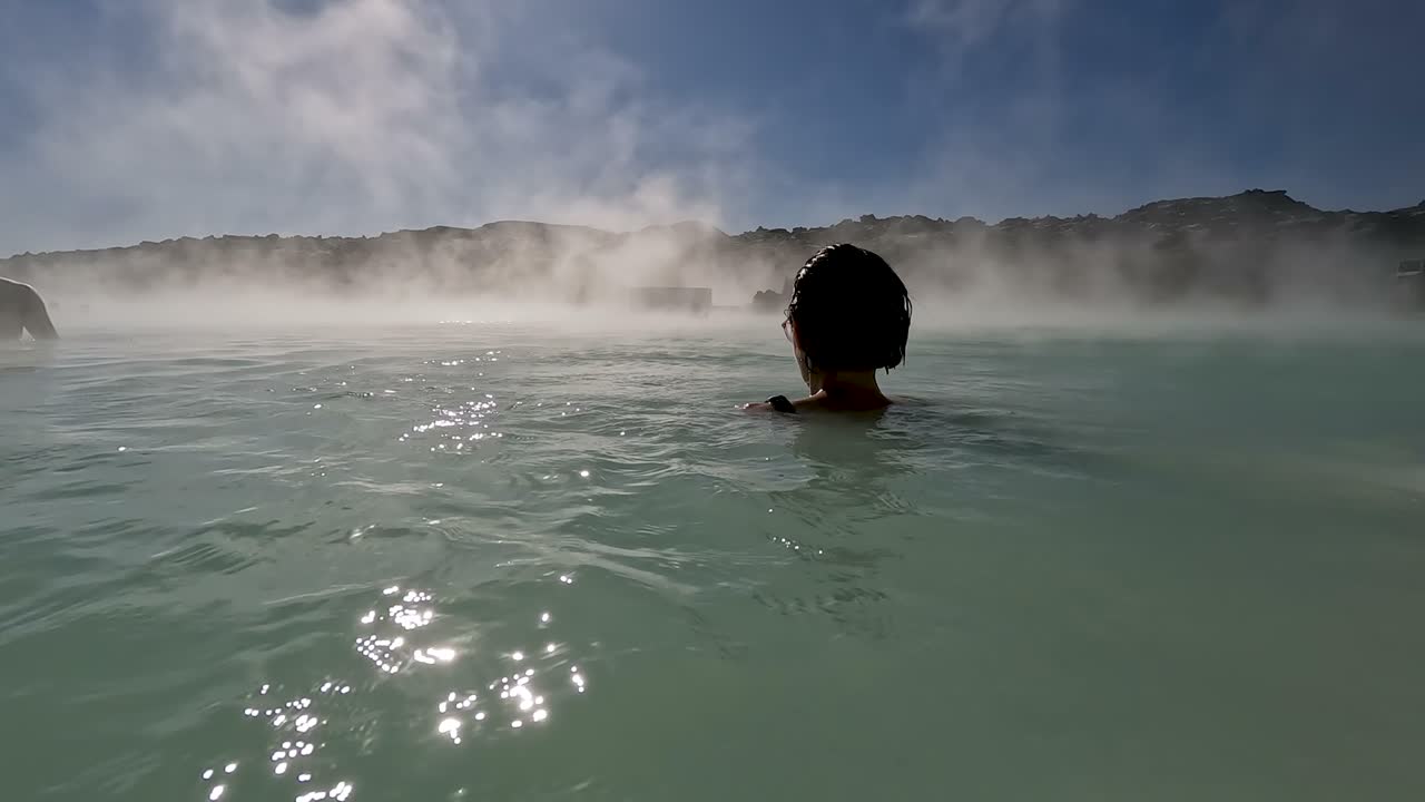 Soaking in an Icelandic hot spring at dusk